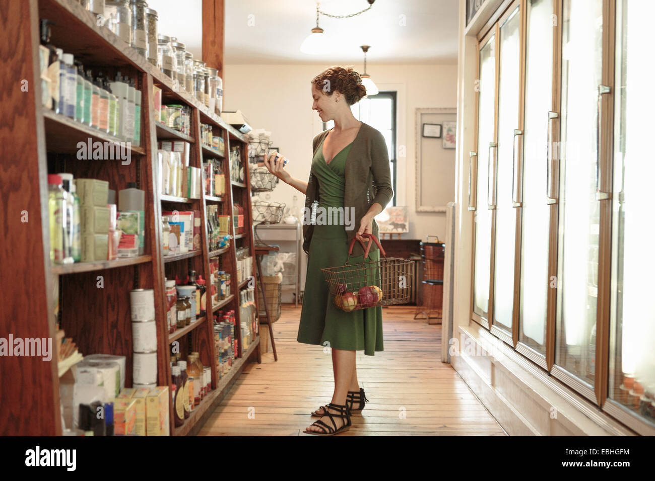 Clienta seleccionando en el estante en Country Store Foto de stock