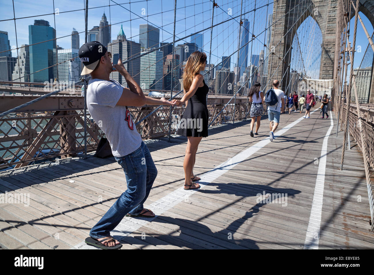 La gente camina a través del Puente de Brooklyn en Nueva York, Estados Unidos. Foto de stock