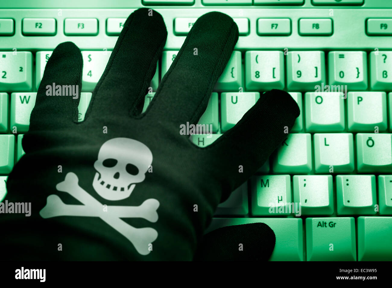 Mano Negra con cráneo símbolo en el teclado del ordenador, la delincuencia  cibernética Fotografía de stock - Alamy
