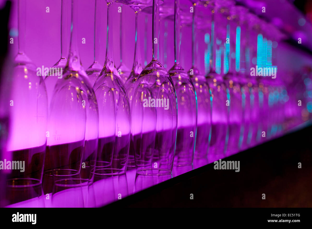 Detalle de Rosa ilumina las copas de vino en un bar. Foto de stock