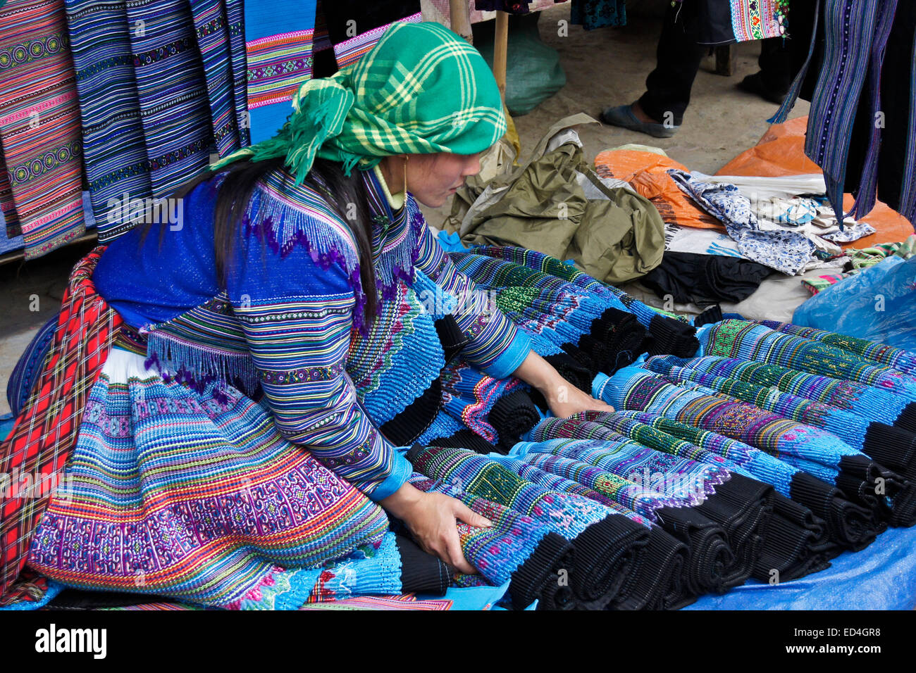Flor Hmong faldas plisada mujer vendiendo en el Mercado Dominical, Bac Ha, Sapa Sa (Pa), Vietnam Foto de stock