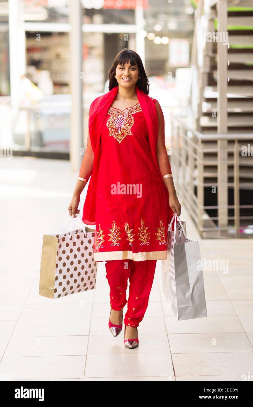 Feliz mujer India llevando bolsas de compras caminando en mall Foto de stock