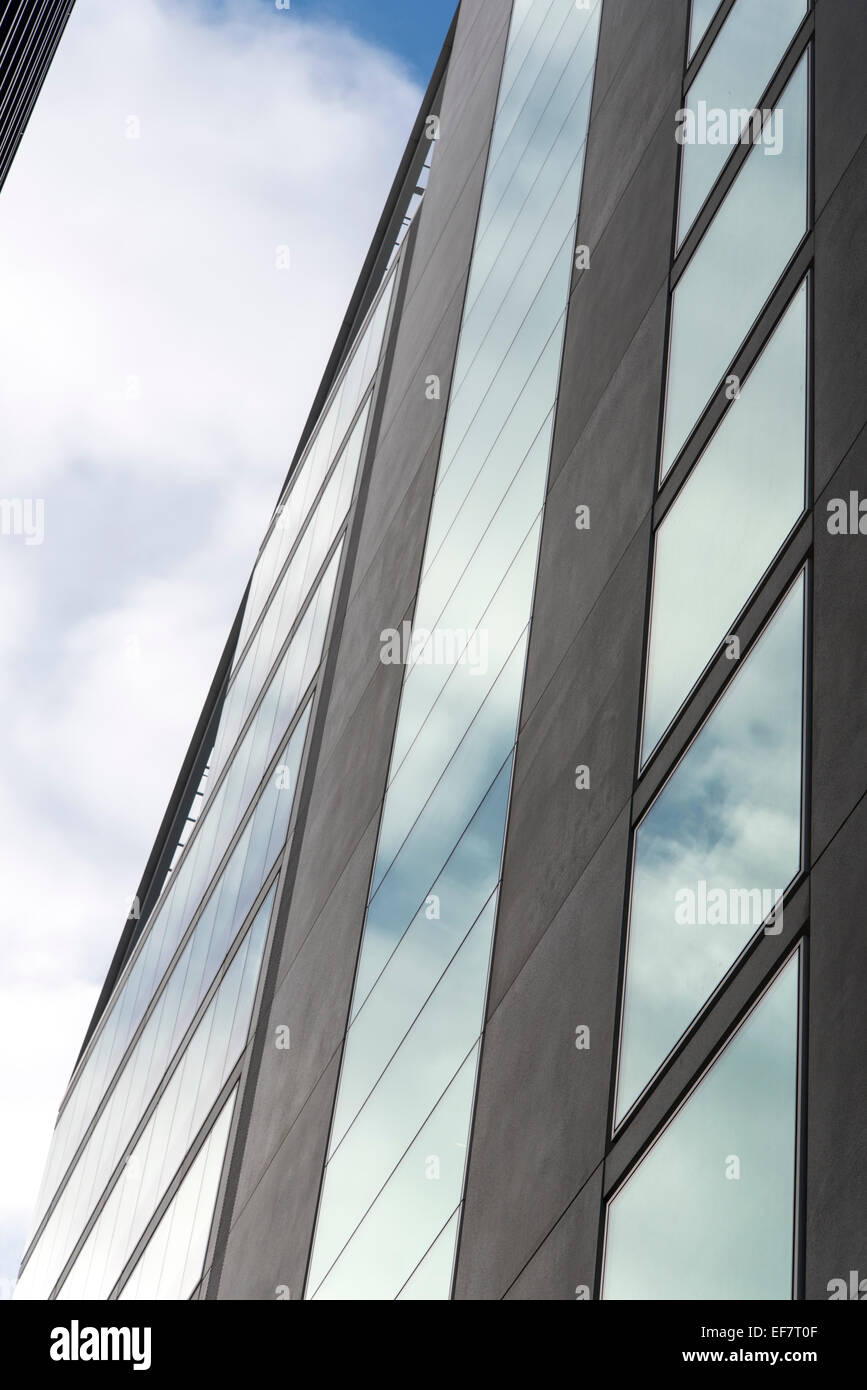 Una vista de un Londres edificio mirando hacia el cielo con reflejos del cielo en las ventanas Foto de stock