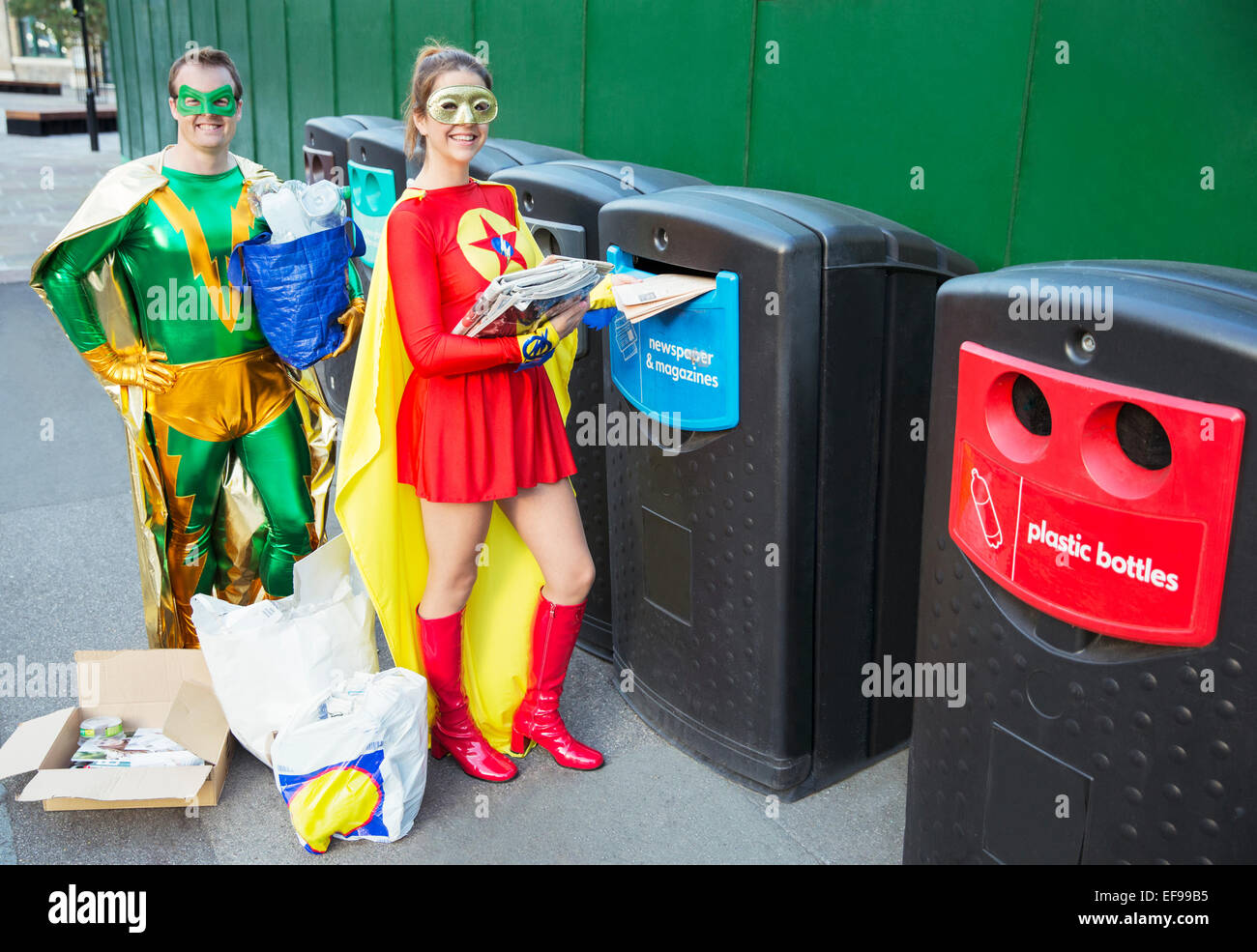 Pareja de superhéroes reciclado sobre las aceras de la ciudad Foto de stock