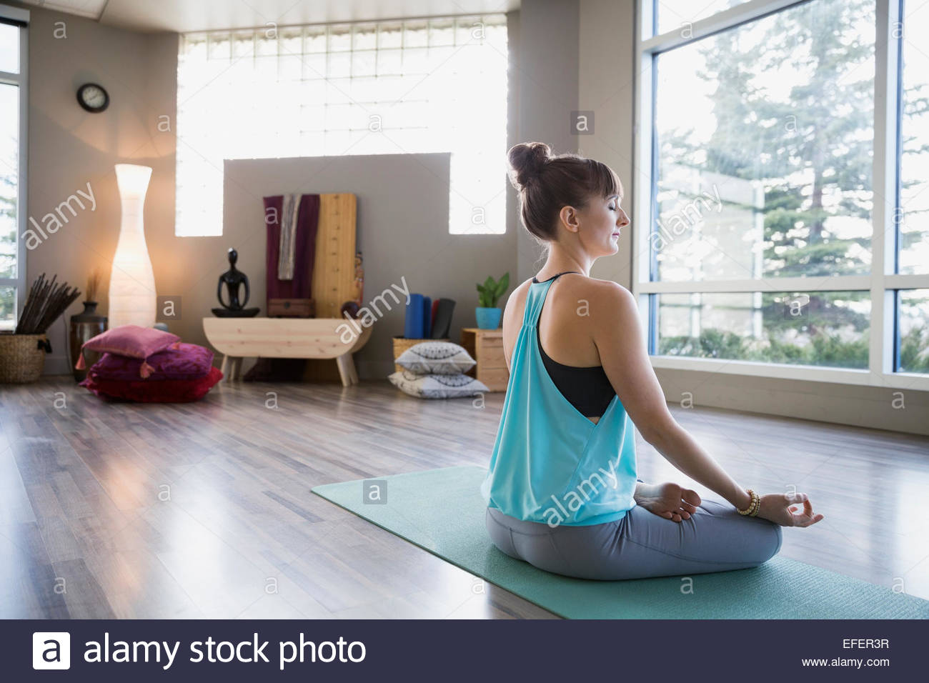 Mujer meditando en posición de loto mudra Foto de stock