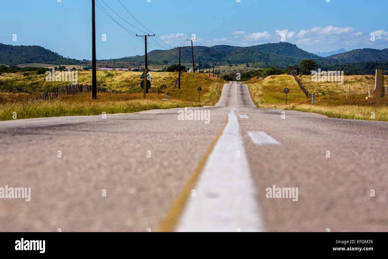 País por carretera con mediana, entre Santa Clara y Trinidad, el Valle de los Ingenios, el Valle de los Ingenios, Cuba Foto de stock