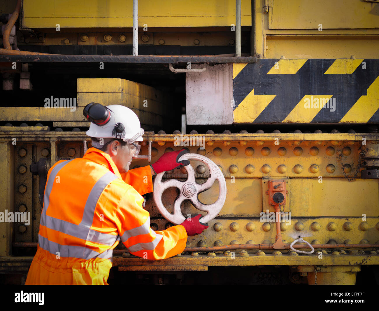 Trabajador ferroviario girando la rueda en tren el ferrocarril de mantenimiento Foto de stock