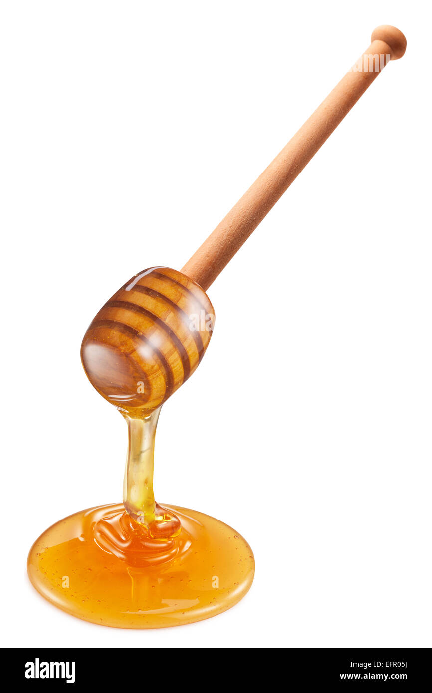 La miel que fluye desde el palo de madera sobre fondo blanco. Los trazados  de recorte Fotografía de stock - Alamy