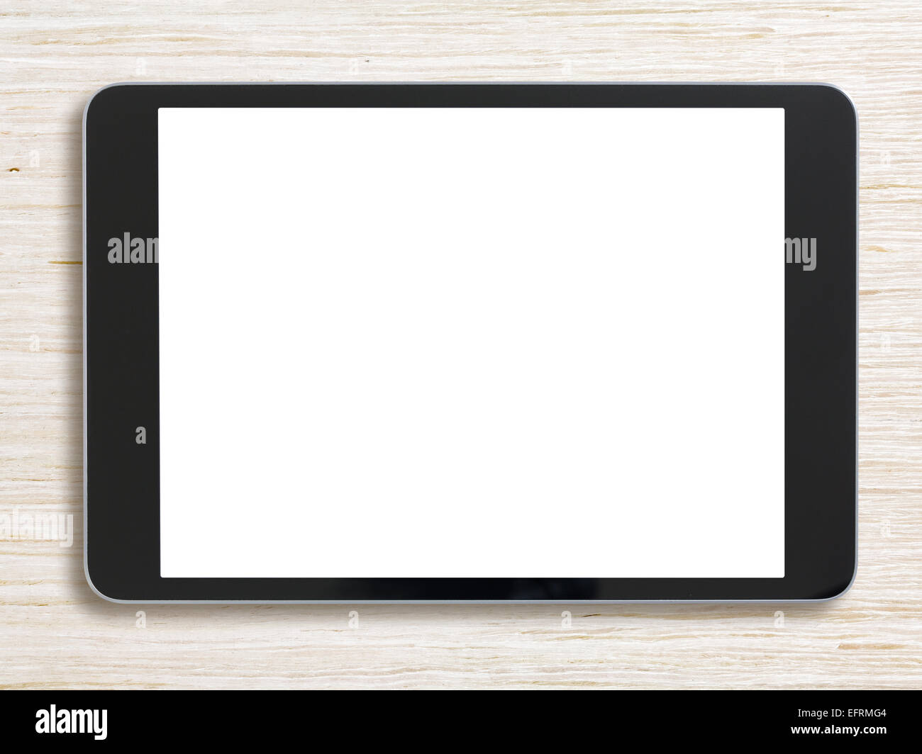 Tablet PC negro sobre fondo de madera blanqueada Foto de stock