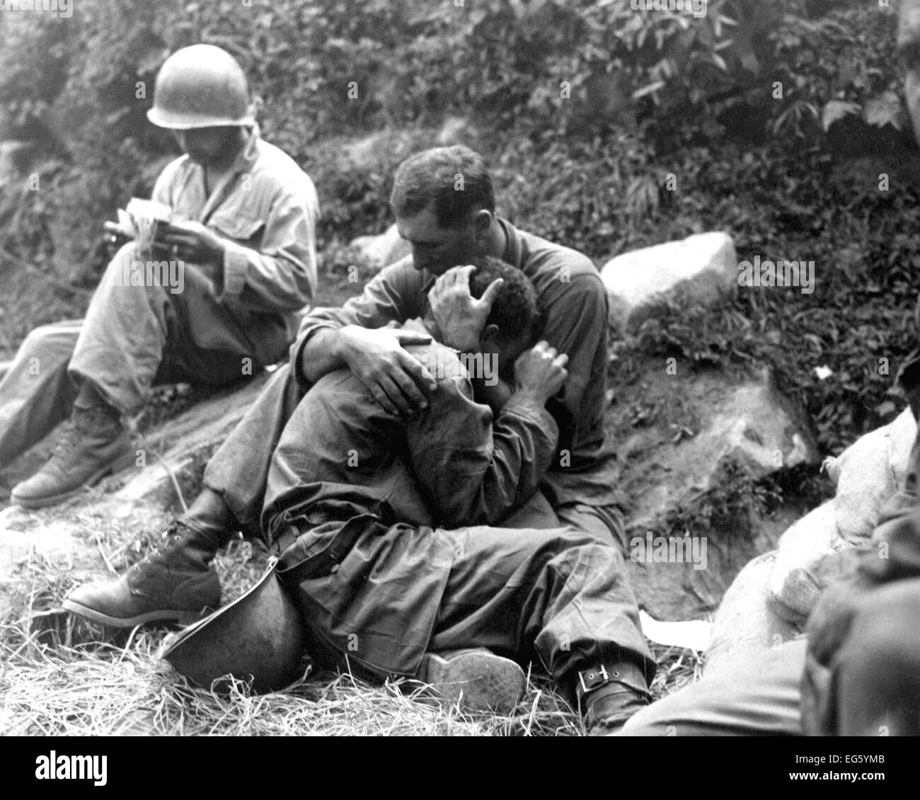 Guerra de Corea (1950-1953), un soldado de infantería estadounidense cuyo amigo ha sido matado es consolada por otro soldado. En el fondo un ayudante médico rellena casualty etiquetas, Haktong-ni zona de Agosto 28, 1950. Foto Al Chang (US Army) Guerra & Conflicto libro #: 1459 Foto de stock