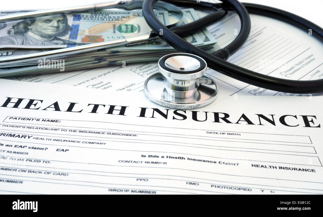 Formulario de seguro de salud con billetes y estetoscopio Foto de stock