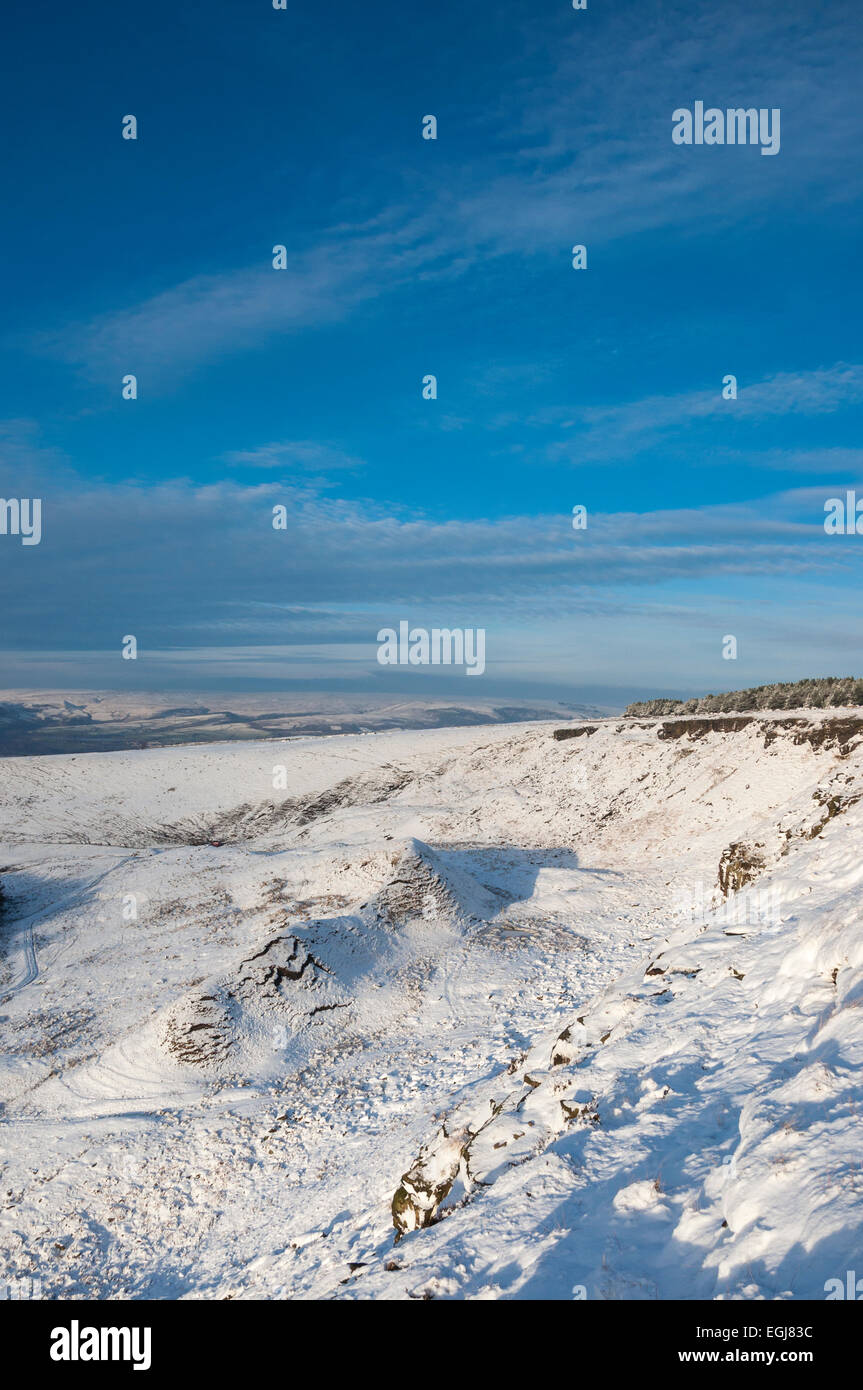 Coombes borde encima de la aldea de Charlesworth cerca Glossop, Derbyshire. Un cielo azul profundo sobre el paisaje nevado. Foto de stock