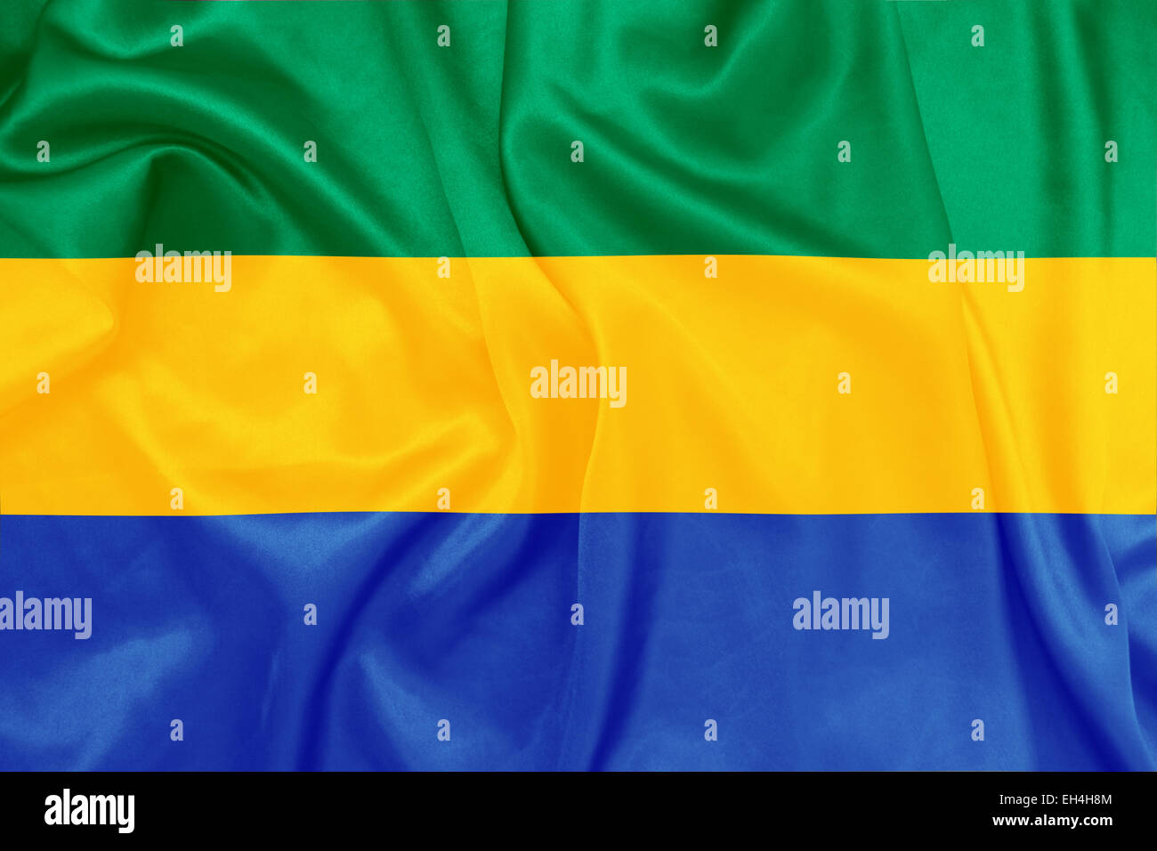 Gabón - ondeando la bandera nacional en la textura de la seda Foto de stock