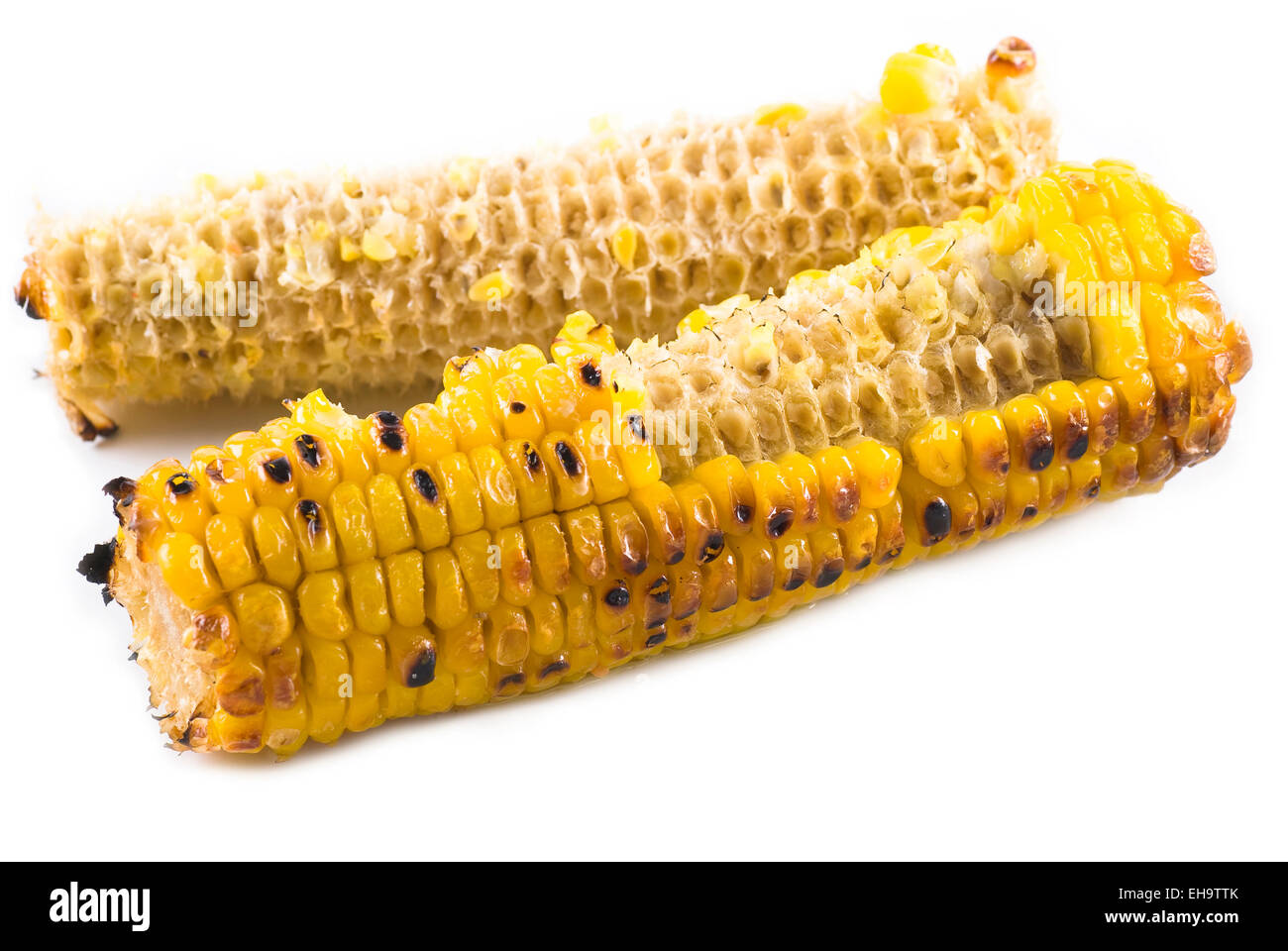 Comen maíz mazorca asada con mantequilla. Foto de stock