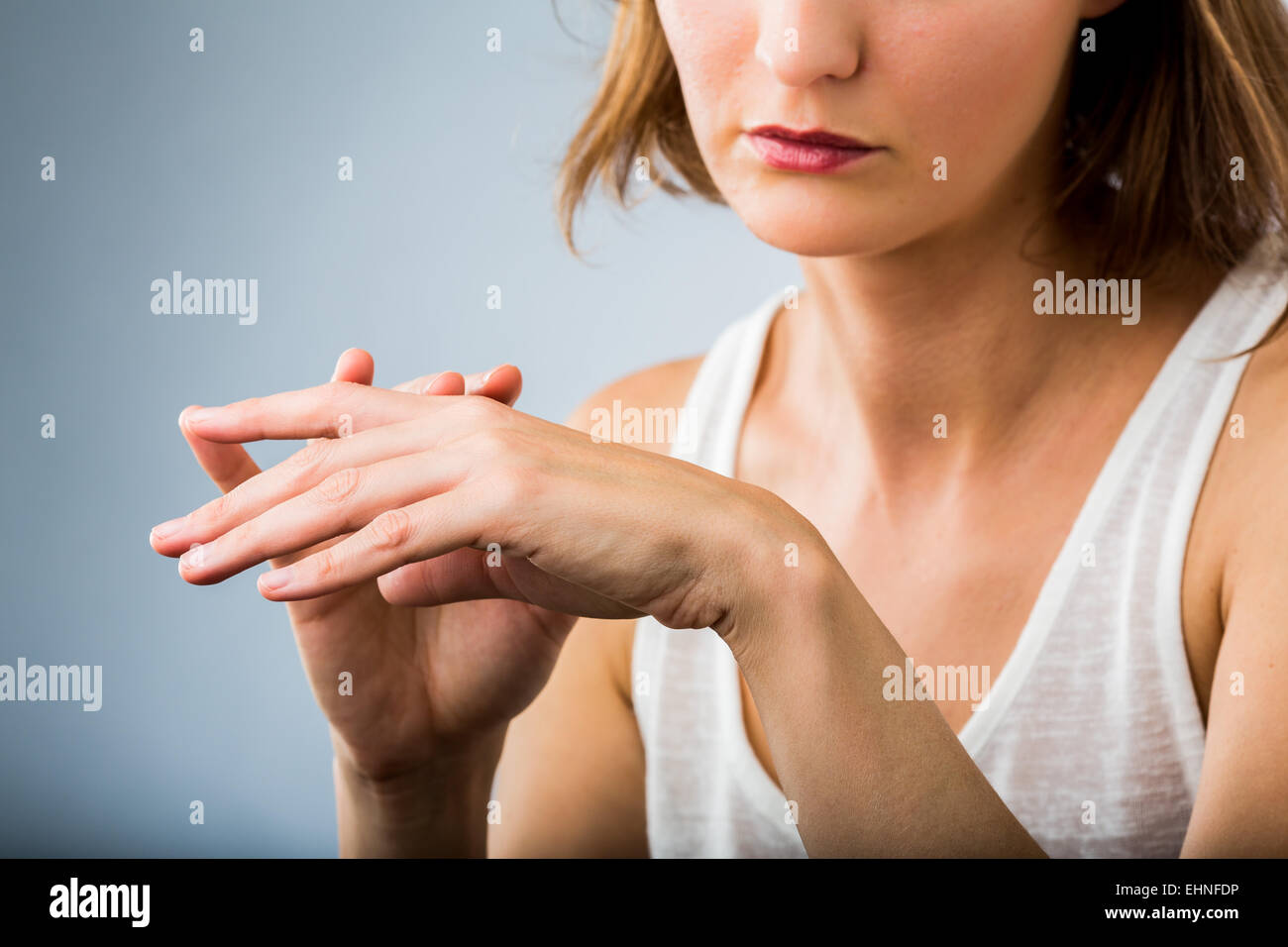 Mujer inspeccionando su mano. Foto de stock
