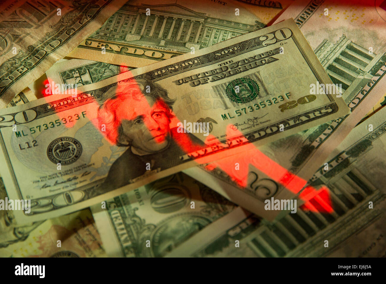 Un rojo "stock market" gráfico proyectado en un montón de Dólares Americanos. Foto de stock