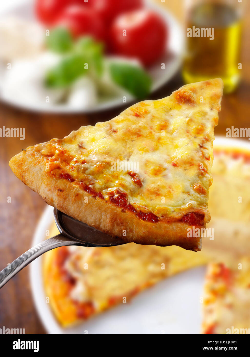 Una rebanada de pizza napolitana Margarita cubiertos con queso Foto de stock