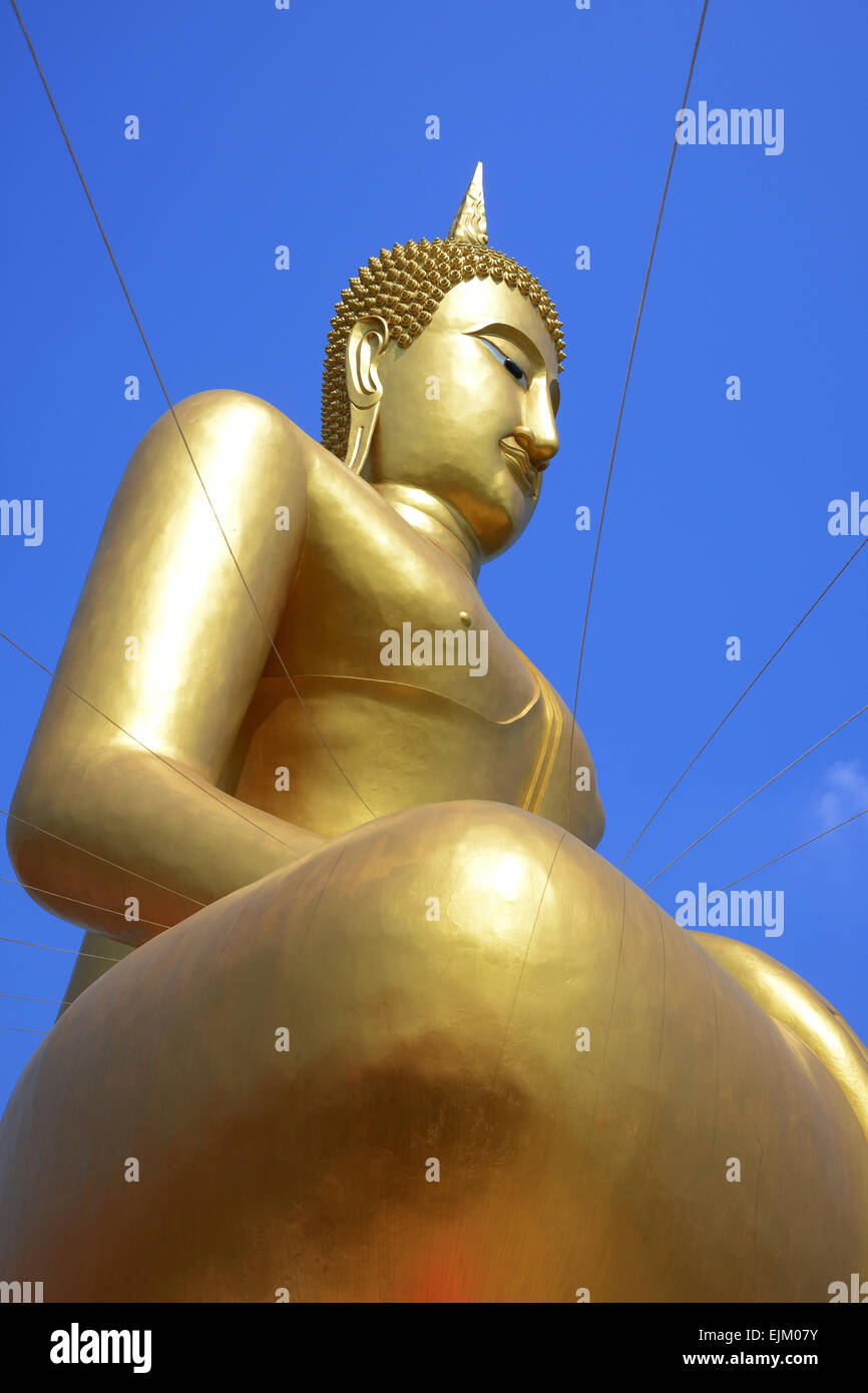 Meditar sentado buda de oro sobre fondo de cielo azul. Foto de stock