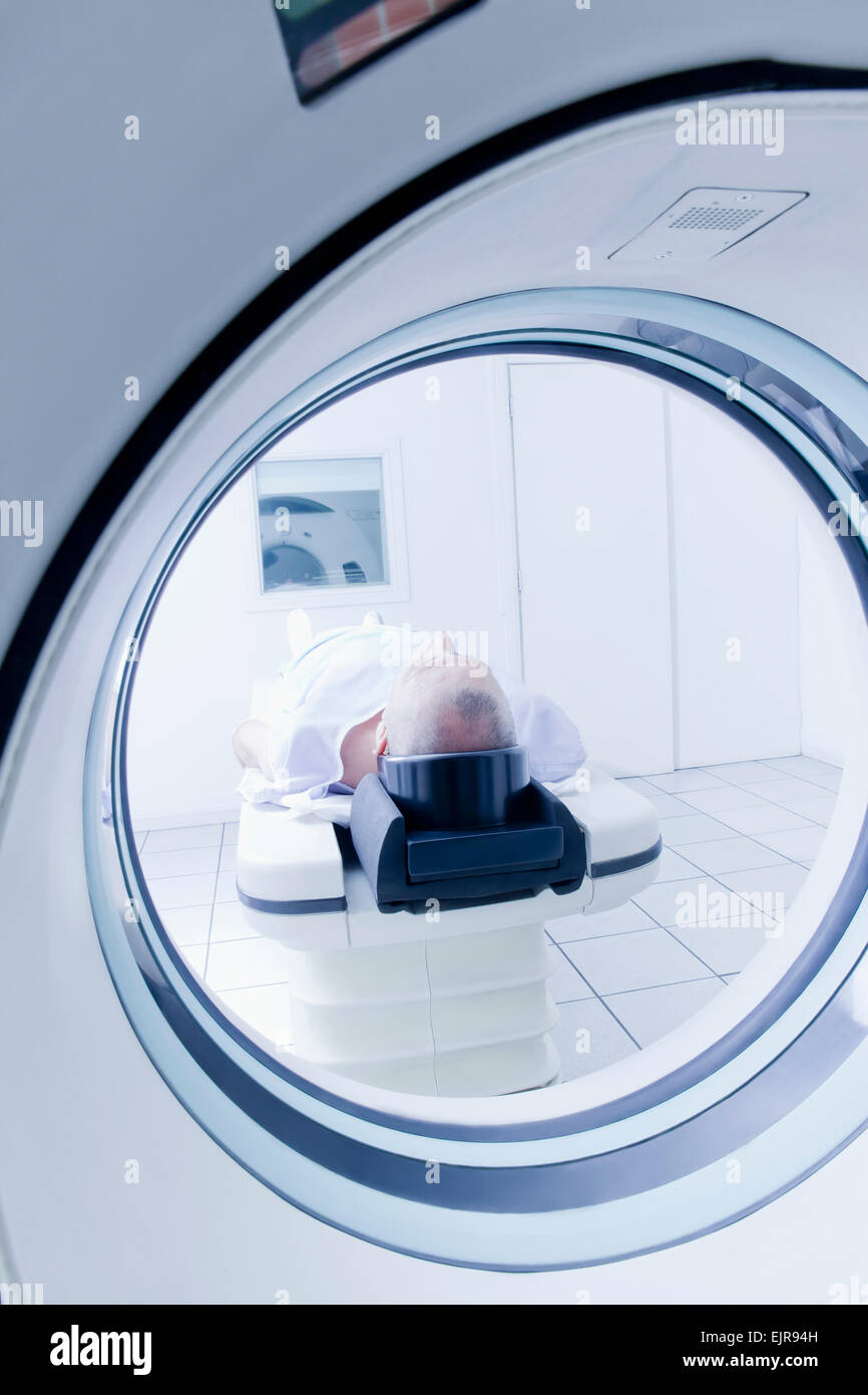 Hombre hispano de mayor edad poniendo en escáner de RM Foto de stock