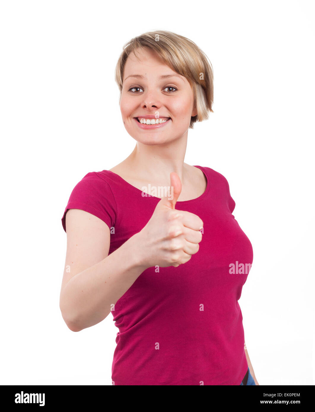Mujer joven mostrando su pulgar hacia arriba en una actitud confiada, aislado en blanco Foto de stock