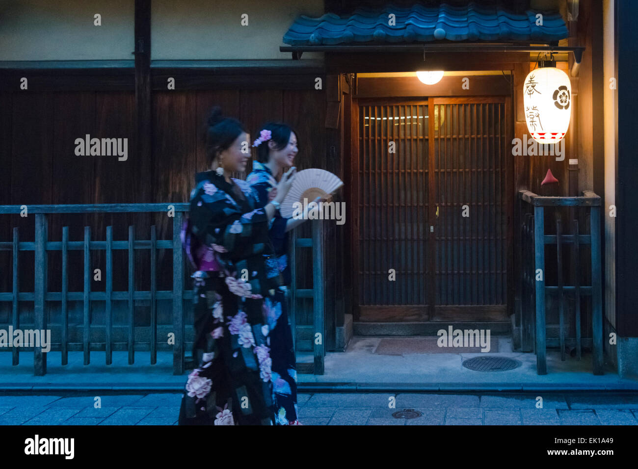 Mujer en kimono caminando por la calle estrecha en el distrito Gion, Kioto, Japón Foto de stock