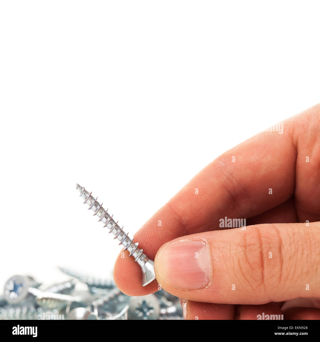 Clavos de plata en mano humana Fotografía de stock - Alamy