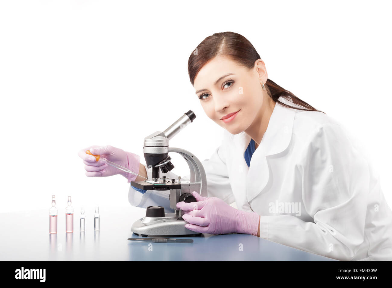 Doctora o investigador científico utilizando microscopio en un laboratorio. Foto de stock