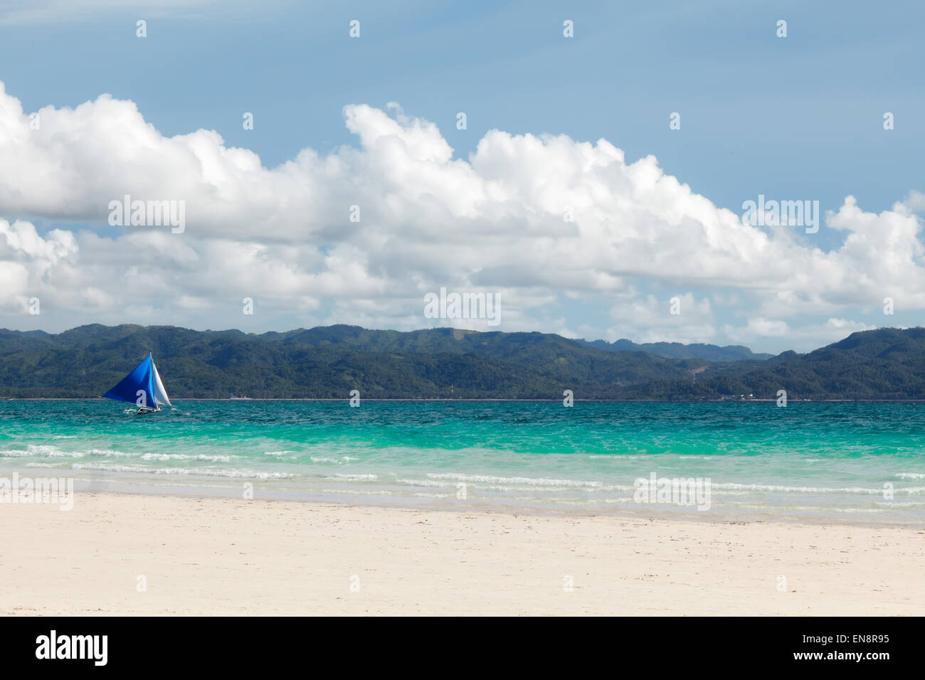 Azul pequeño velero en el horizonte del mar azul con nubes blancas grandes Filipinas Boracay Island Foto de stock