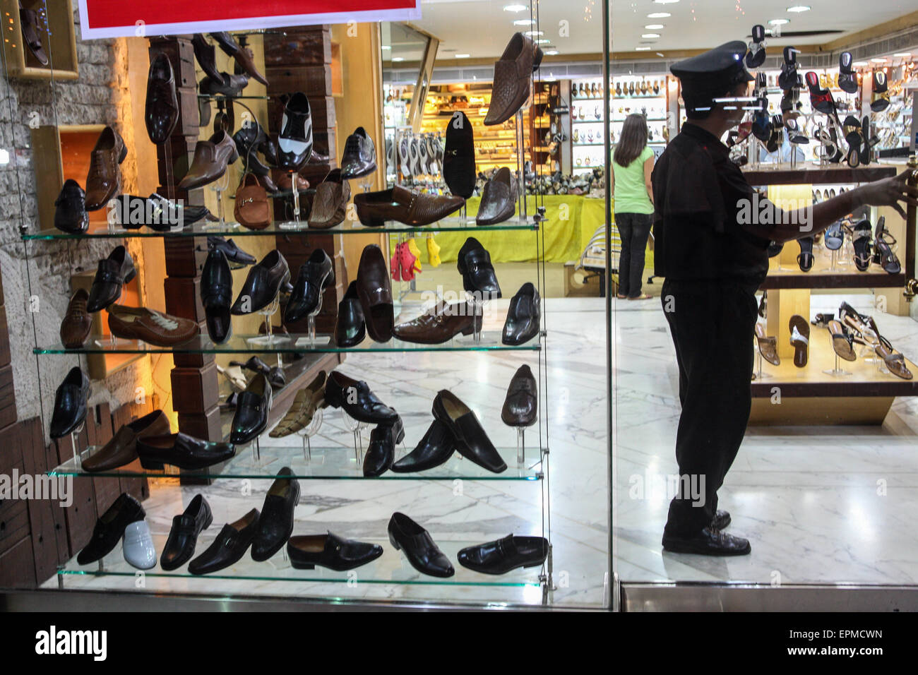 Tienda de moda joven indios en esta tienda de zapatos, puerta tripulada por el guardia de seguridad, en de Colaba Mumbai/Bombay, India económica Fotografía de stock - Alamy
