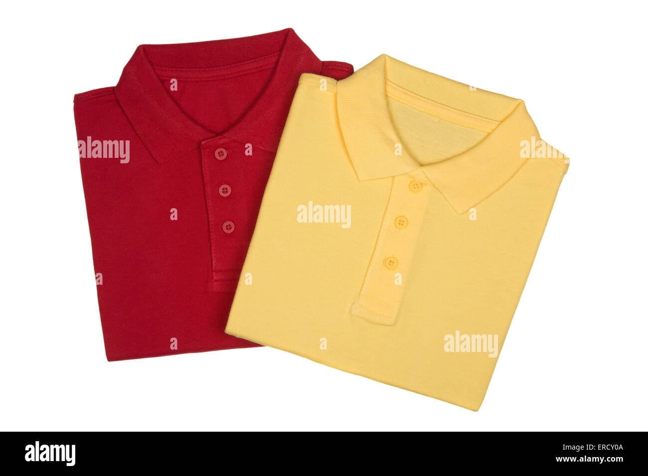 Plegar dos camisetas rojas y amarillas sobre fondo blanco aisladas desde arriba Foto de stock