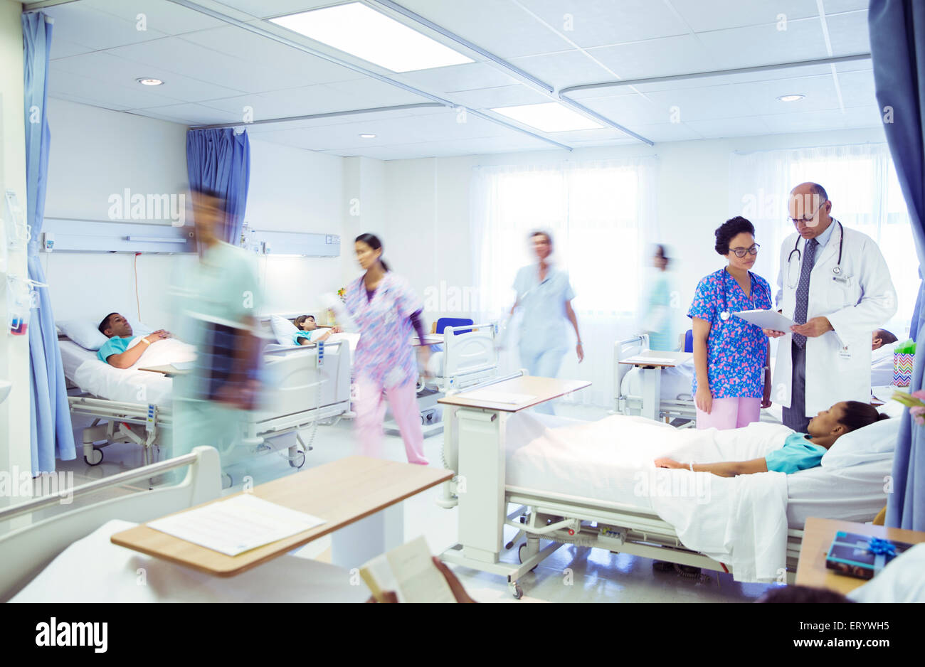 Los médicos y las enfermeras haciendo rondas en el cuarto del hospital