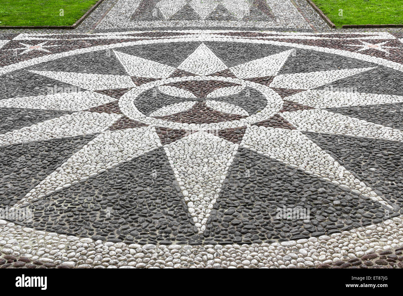 Una piedra mosaico que representa un período de 12 puntas de la estrella, situado a la entrada de la iglesia. Foto de stock