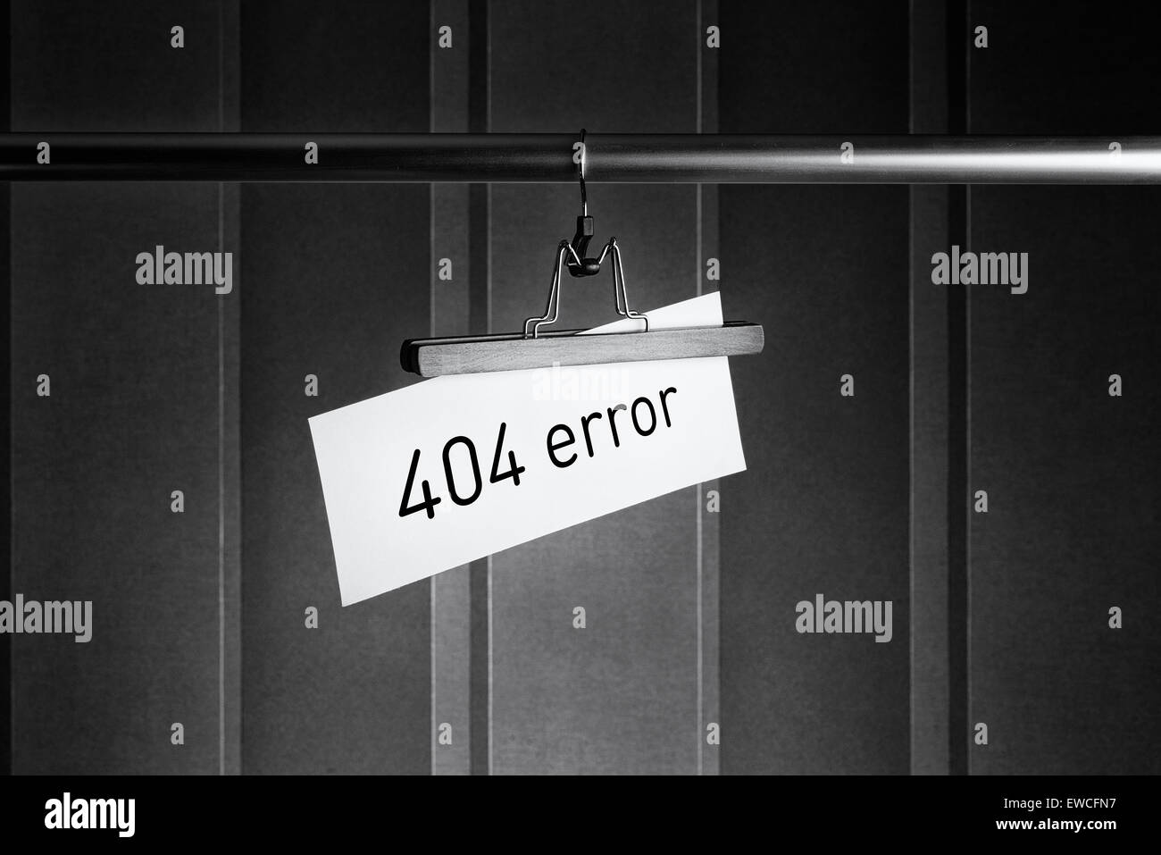 Imagen en blanco y negro de una percha pantalones con una etiqueta en la que está escrito "error 404" Foto de stock