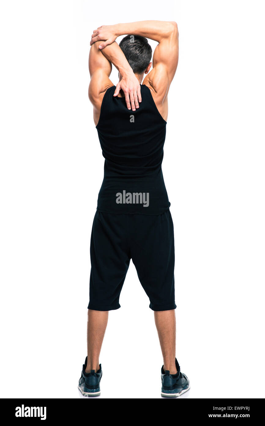 Longitud total retrato de un hombre fitness estiramiento manos aislado sobre un fondo blanco. Foto de stock