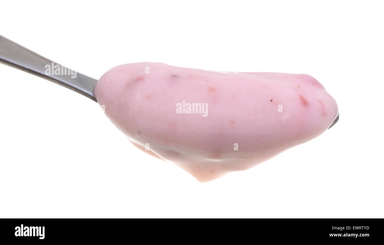 Vista lateral de una pequeña porción de yogur de fresa en una cuchara contra un fondo blanco. Foto de stock