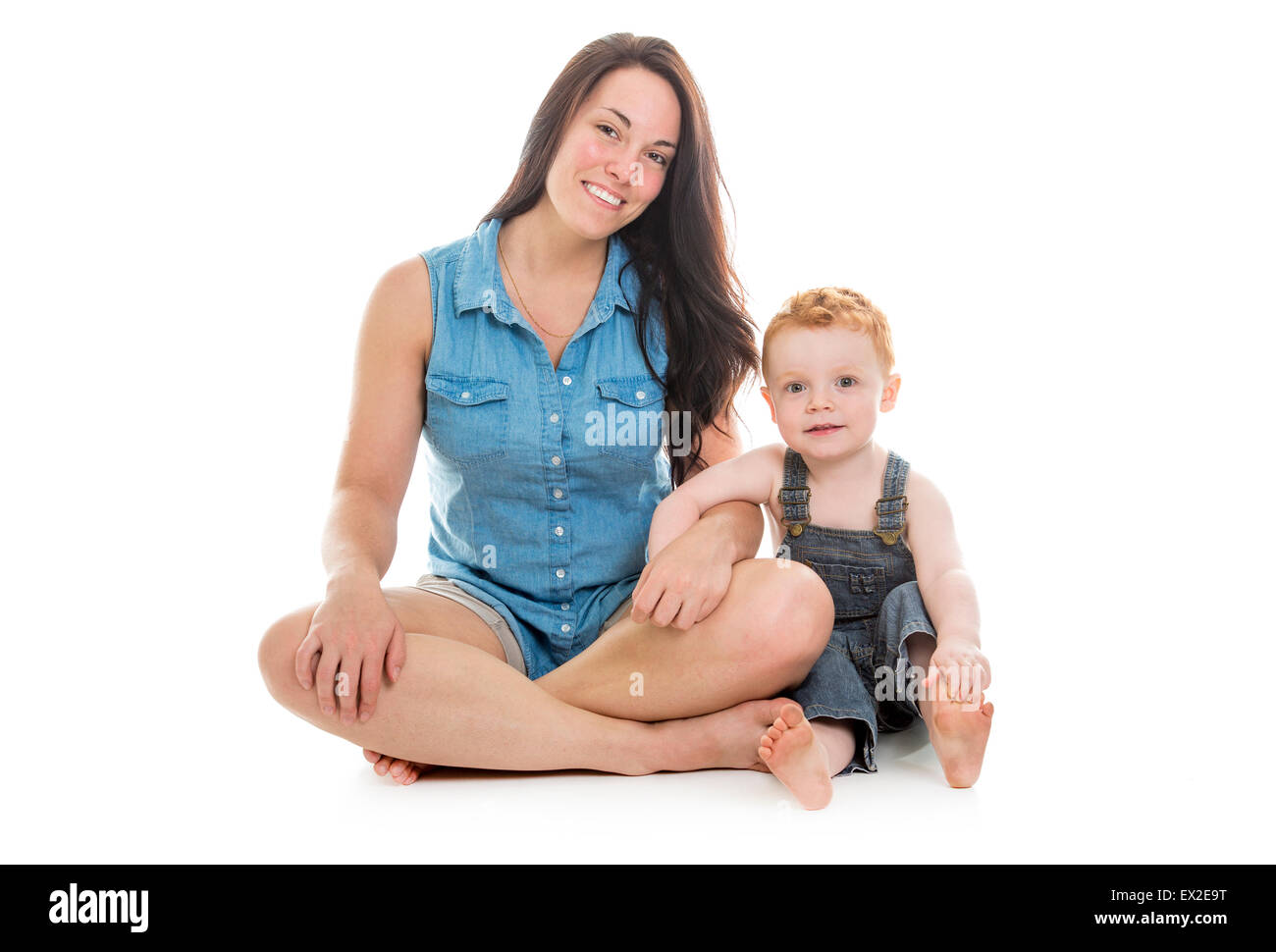 Baby Boy con su madre sobre un fondo blanco aislado Foto de stock