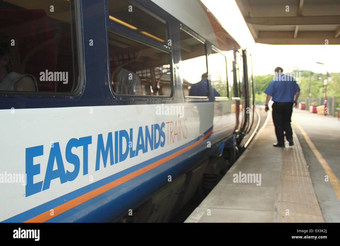 Un conductor de tren se aproxima a la cabina de un tren East Midlands en Matlock railway station, Derbyshire, Inglaterra Foto de stock