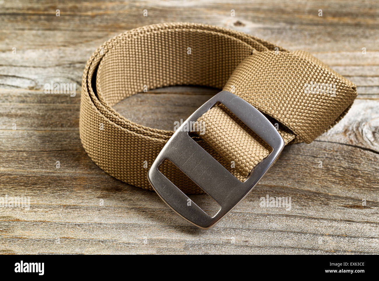 Vista de cerca de una marca nueva utilidad cinturón con hebilla grande  sobre tablones de madera rústica Fotografía de stock - Alamy