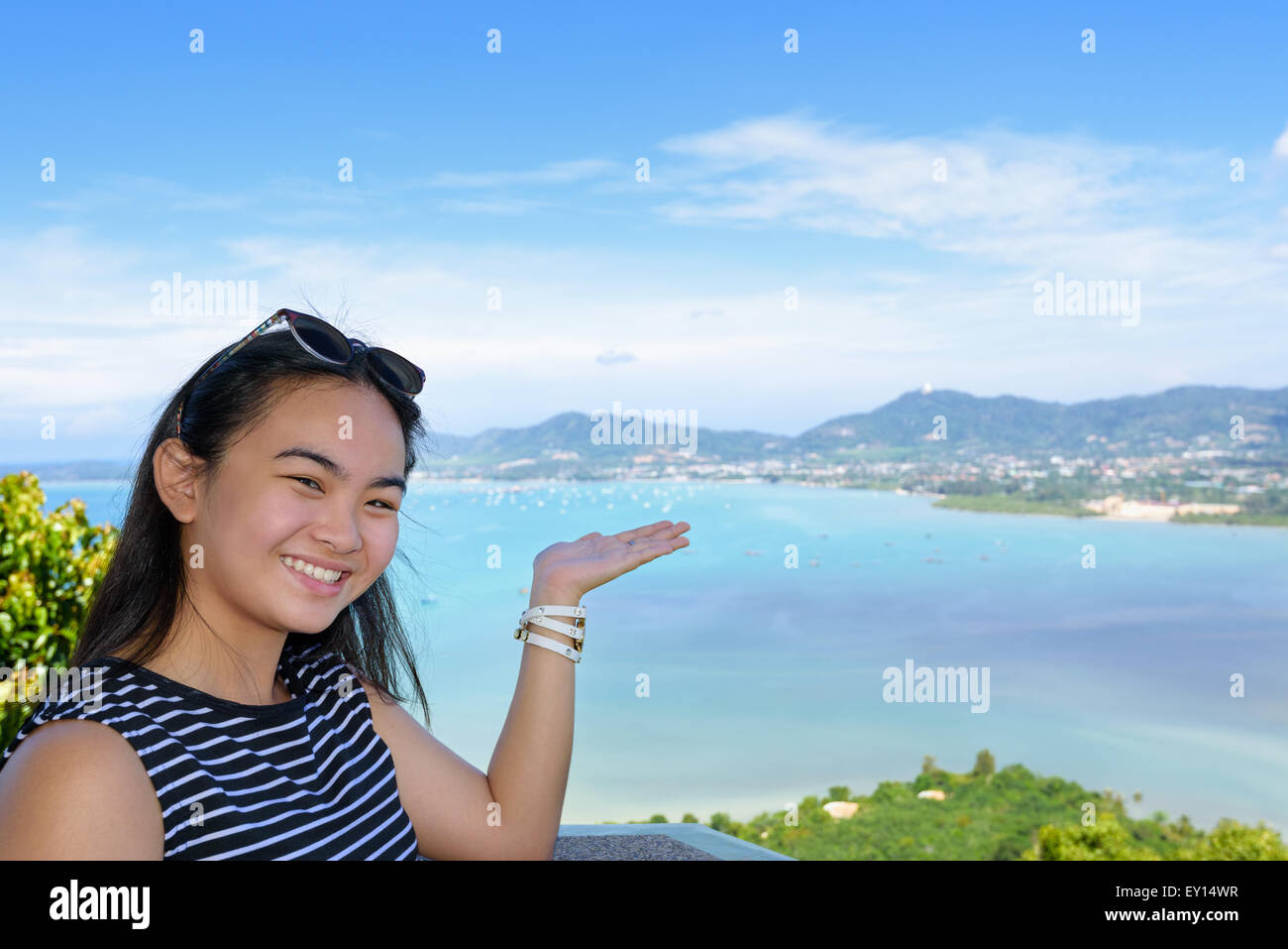 Mujer sonriente turísticas están encantados de mostrar su mano para invitarlos a ver el hermoso paisaje de mar sobre la montaña Khao-Khad viewp Foto de stock