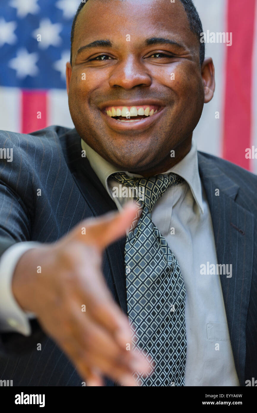 Negro sonriente político ofreciendo handshake Foto de stock