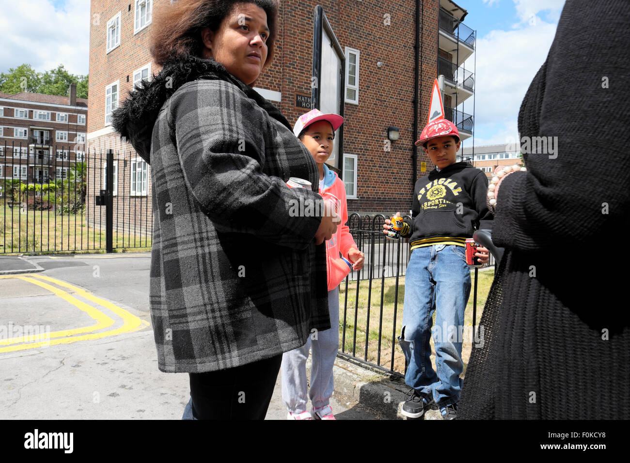 Mujer hablando con dos chicos jóvenes que buscan en la urbanización de East London UK KATHY DEWITT Foto de stock