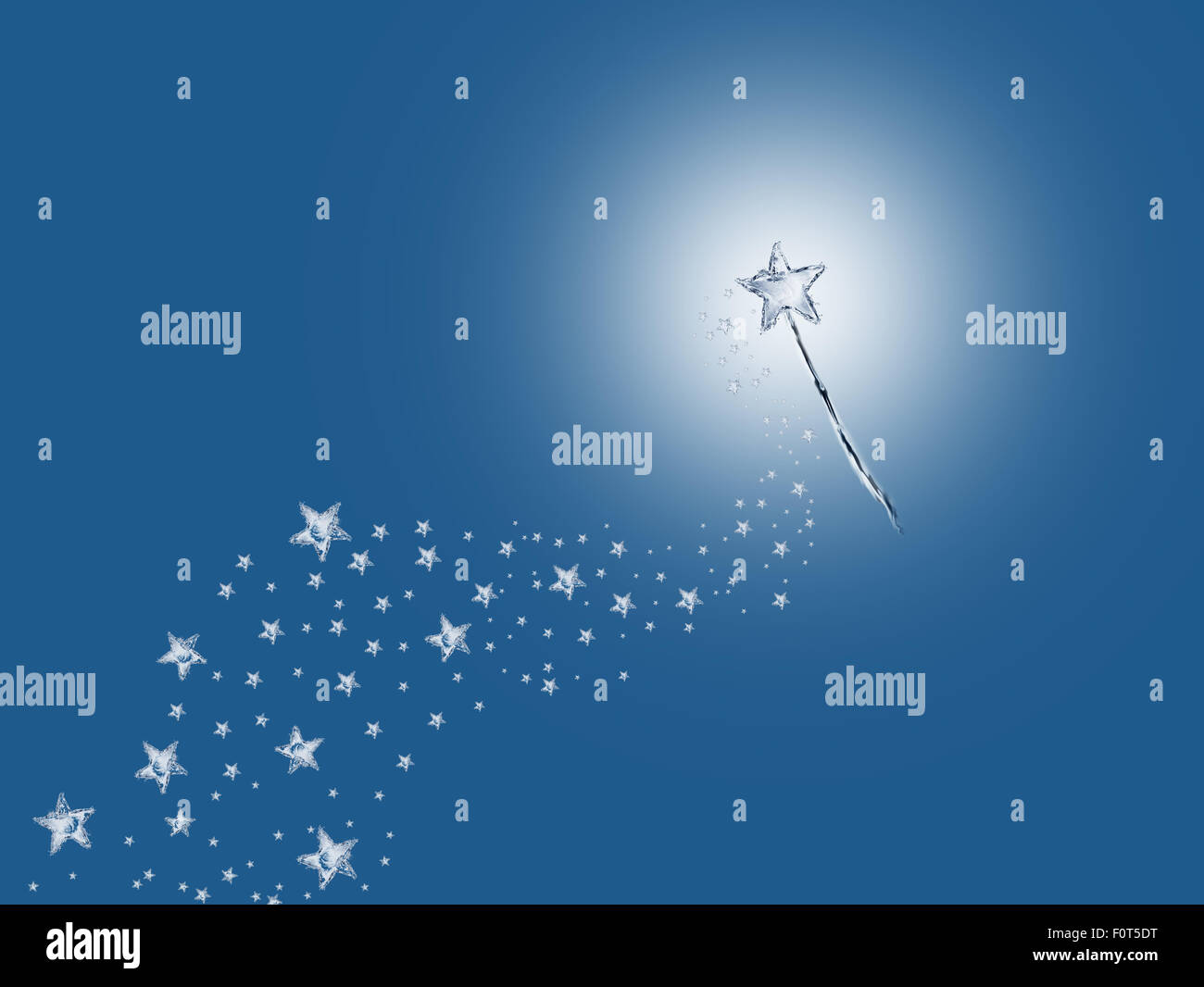Una varita mágica de agua dejando un rastro de estrellas. Foto de stock