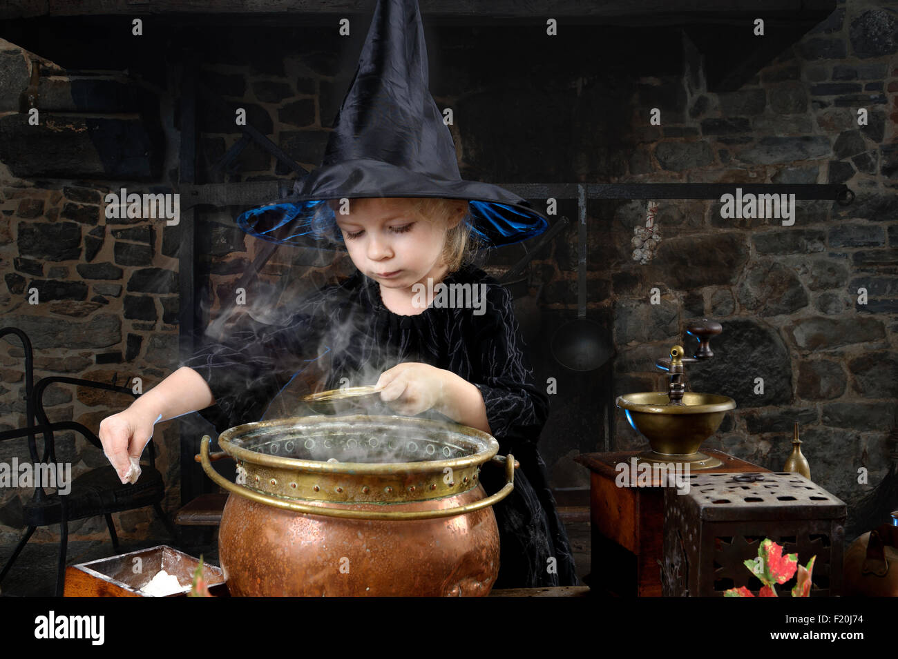 Pequeña Bruja de Halloween con caldero en una antigua cocina Fotografía de  stock - Alamy
