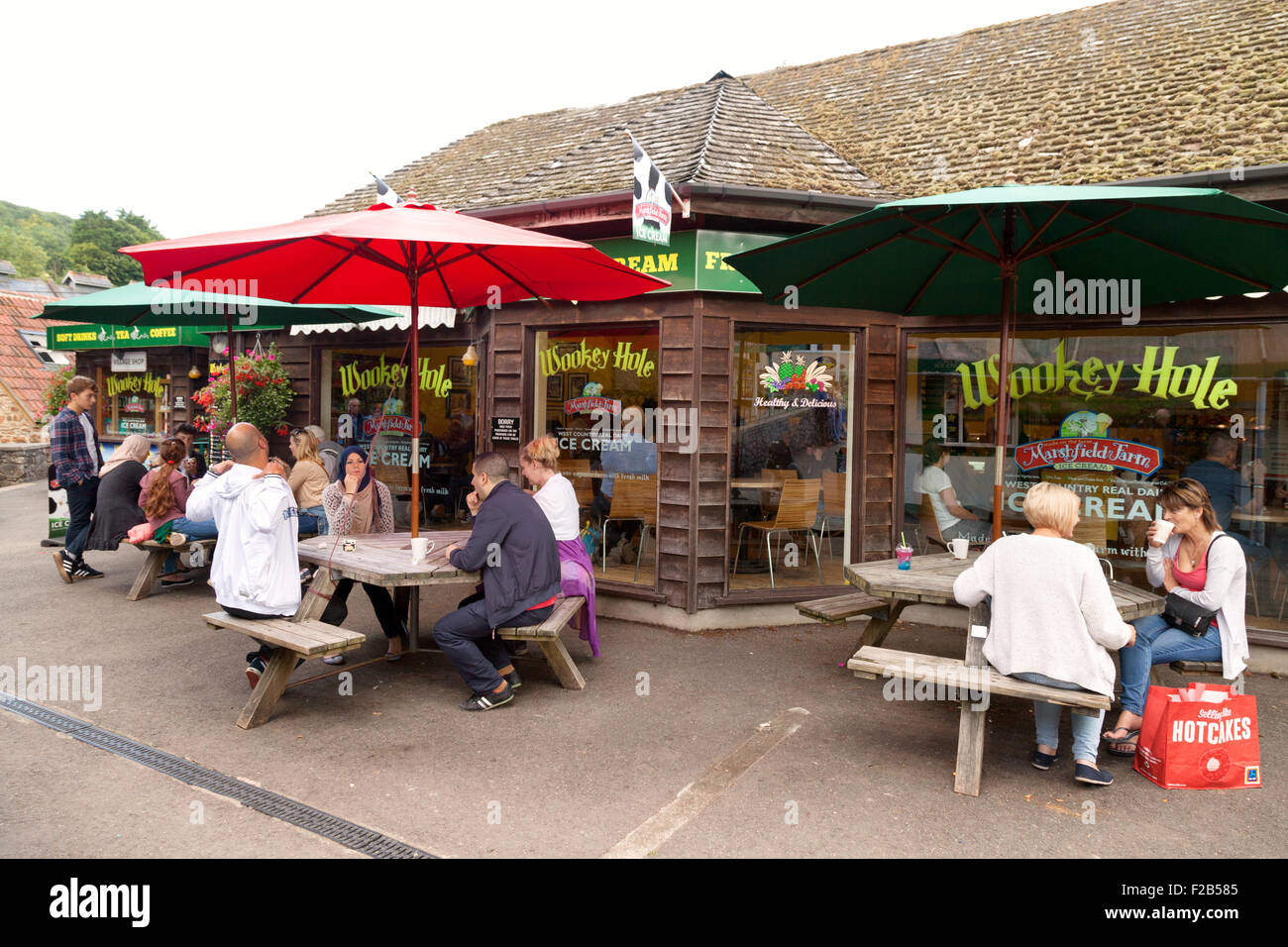 Los turistas sentados en un café, Wookey Hole atracción turística, Somerset, Inglaterra Foto de stock