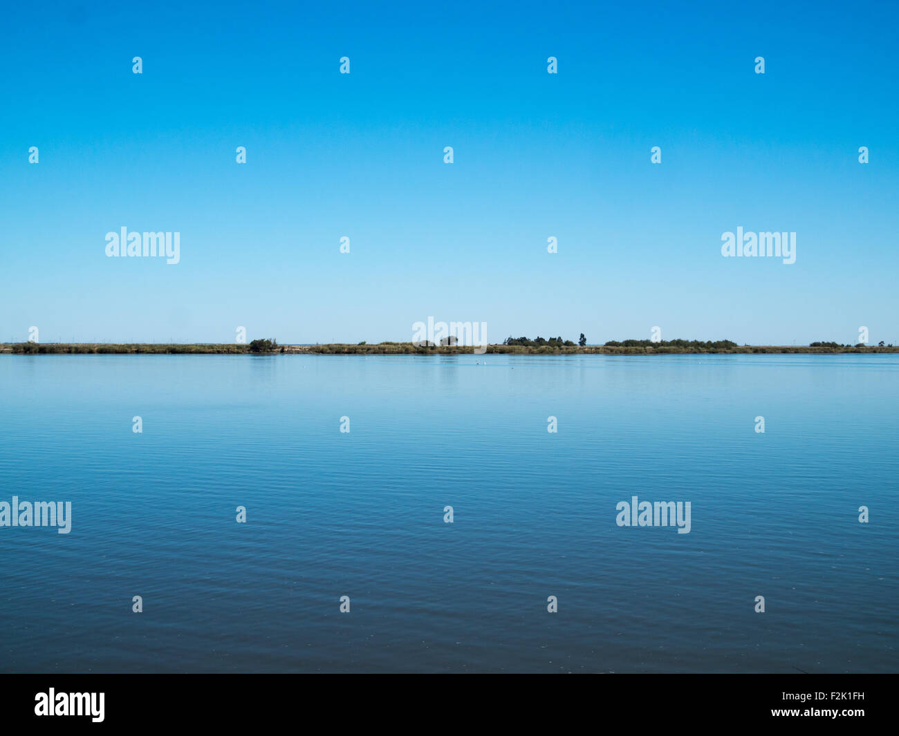 Línea de horizonte entre el azul del cielo y el agua Foto de stock