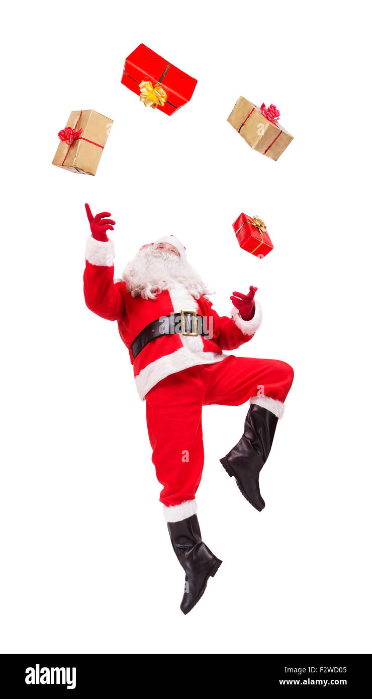 Santa Claus malabares con regalos de Navidad aisladas sobre fondo blanco. Foto de stock
