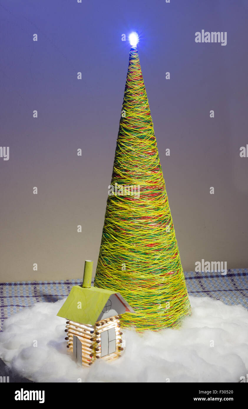 Árbol artificial de subprocesos en la casa y decorada casa de coincidencias y nieve de algodón Foto de stock