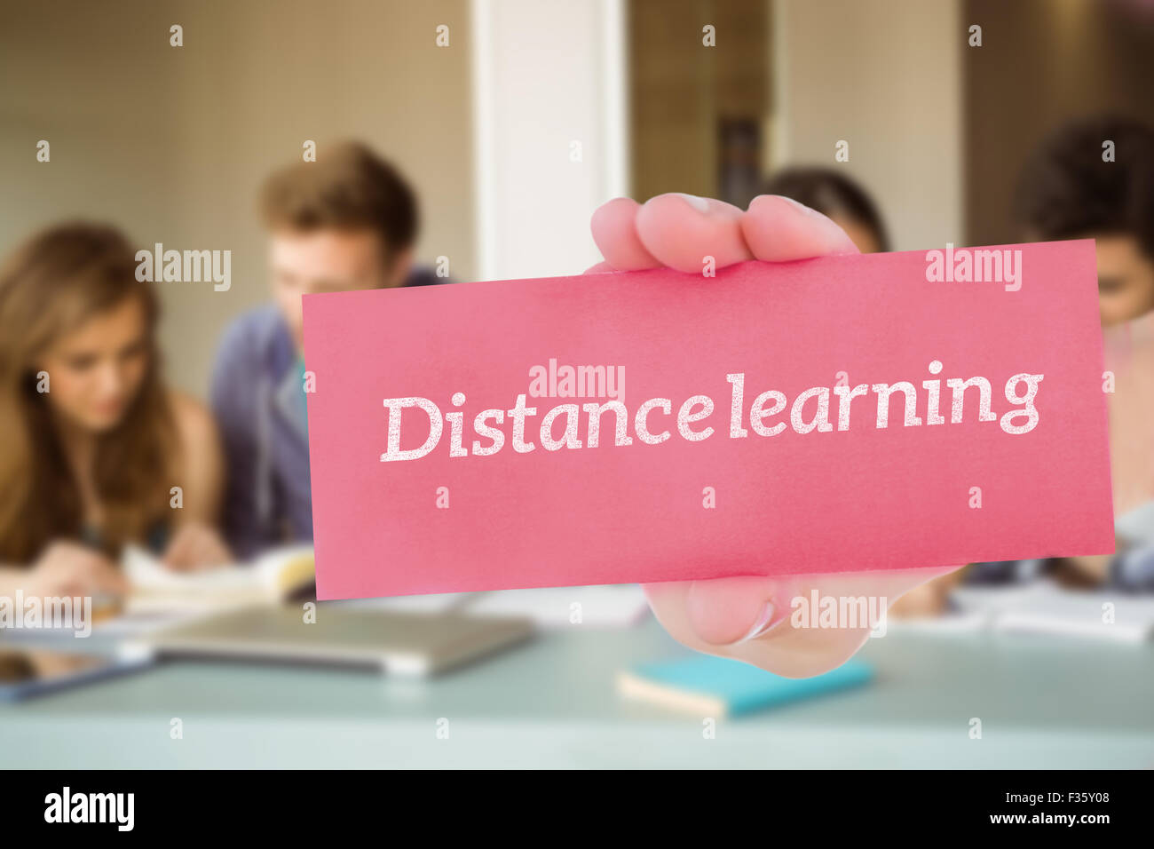 El aprendizaje a distancia contra sonriendo amigos estudiantes revisar juntos Foto de stock