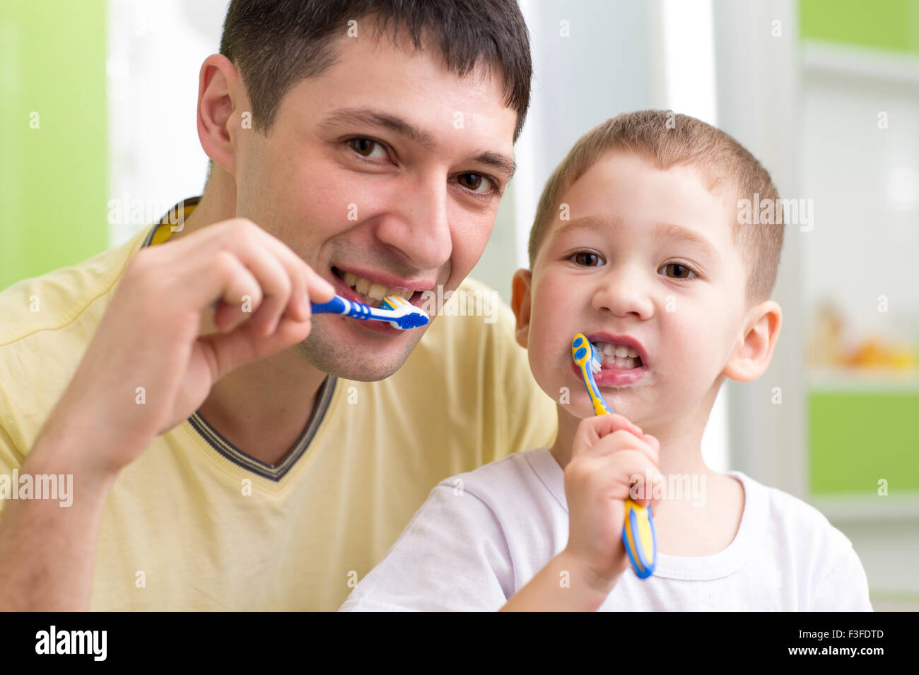 Niño Y Su Padre Cepillarse Los Dientes En El Baño Fotografía De Stock