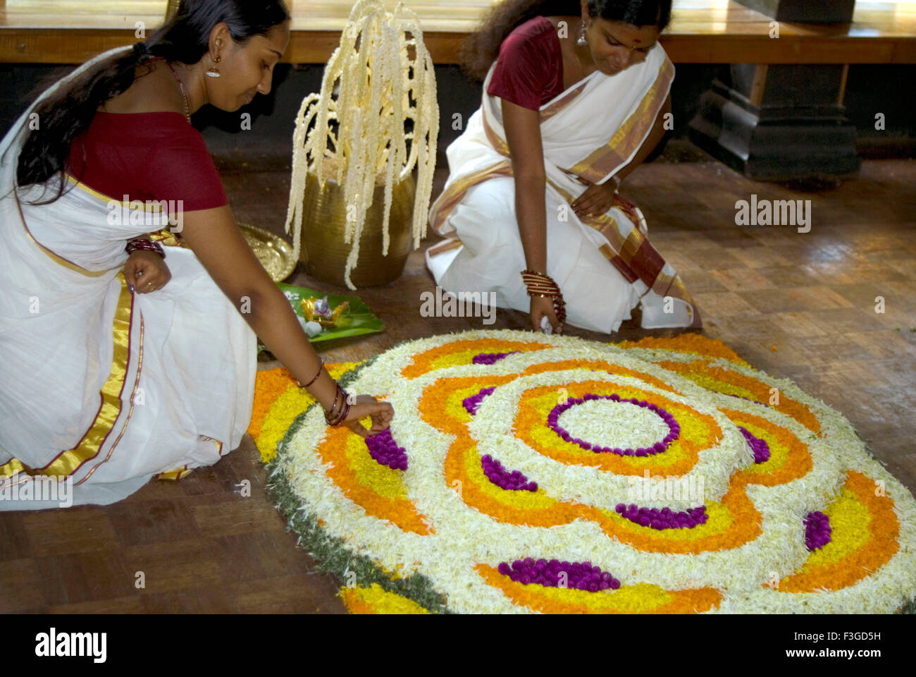 Las señoras jóvenes vestidas en estilo kerala sentar athapoov Durante Onam ; Trivandrum, Kerala ; ; La India no hay modelo de liberación Foto de stock